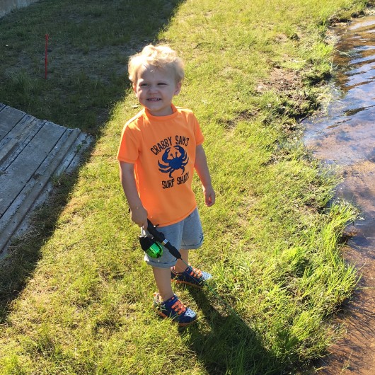 Practicing for when he can enter the fishing derby next year.